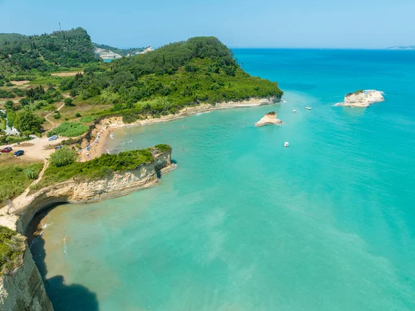 Aerial view of the cliff overlooking the sea near Apotripiti beach and of Mermaid's rock, a promontory on the crystal clear sea. Corfu island, Greece, Ionian sea