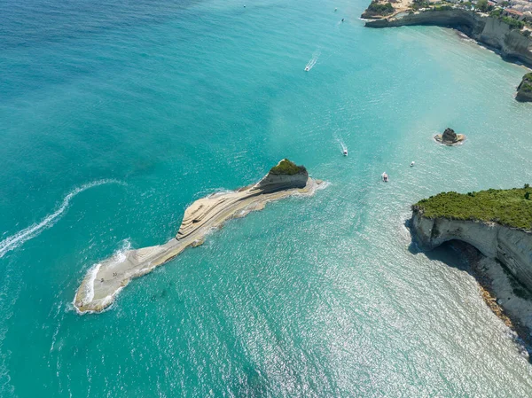 Aerial view of the cliff overlooking the sea near Apotripiti beach and of Mermaid`s rock, a promontory on the crystal clear sea. Corfu island, Greece, Ionian sea.