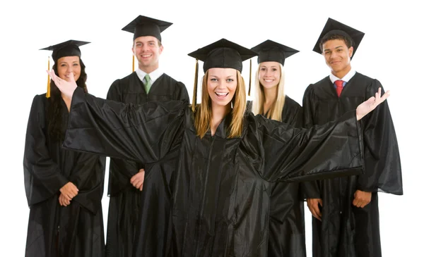 Graduação: Garota excitada com outros graduados por trás — Fotografia de Stock