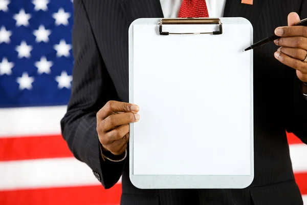 Politician: Pointing to a Blank Paper on a Clipboard — Stock Photo, Image