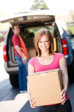 Storage: Woman Carries Box from Truck clipart