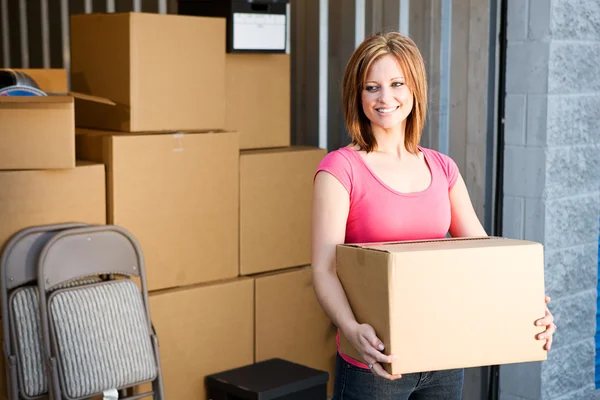 Storage: Woman with Boxes Behind — Stock Photo, Image