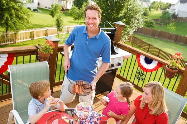 Sommer: Papa serviert Hamburger und Hot Dogs — Stockfoto