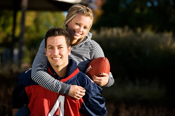 Football : Girlfriend Rides Piggyback — Photo