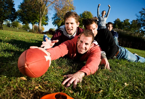 Football: Tackled Guy Tries for Touchdown Stock Photo