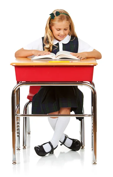 Student: Girl At Desk Reading Book Stock Photo