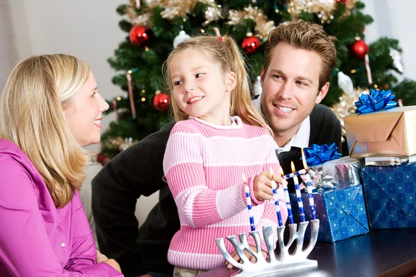Holidays: Fun Family Time Lighting Menorah Royalty Free Stock Photos