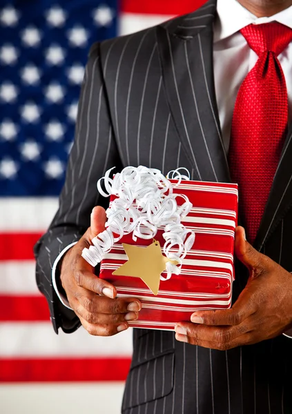 Politician: Holding a Christmas Present — Stock Photo, Image