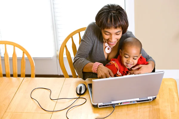 Семья: парни учат мальчика пользоваться компьютером — стоковое фото
