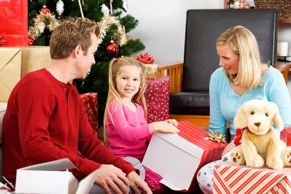 Christmas: Girl Unwrapping Large Gift Royalty Free Stock Images