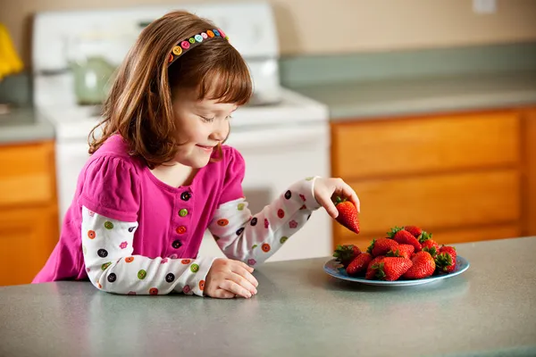 Kitchen Girl: Taking a Strawberry — Stock Image Kitchen Girl: Taking a Strawberry Stock Image