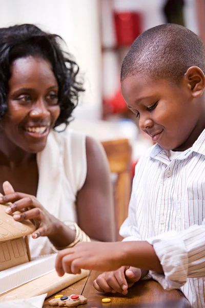 Christmas: Mother And Son Build Holiday Gingerbread House — Stock Photo, Image