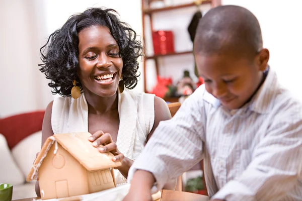 Christmas: Mother And Son Build Holiday Gingerbread House — Stock Photo, Image