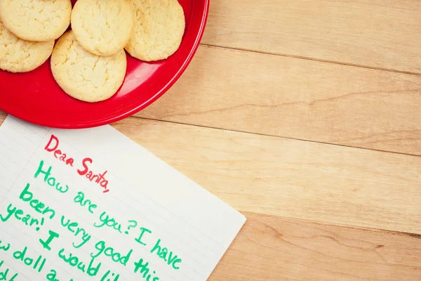 Navidad: Galletas para Santa Claus y lista de deseos —  Fotos de Stock