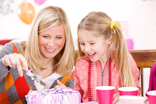 Anniversaire : Mère coupe gâteau d'anniversaire pour fille Photos De Stock Libres De Droits