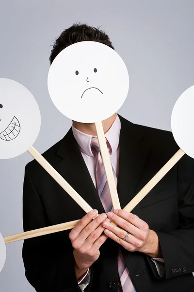 Disguise: Businessman Hiding Behind Variety Of Masks — Stock Photo, Image