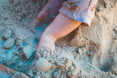 Bebek oyunu konsepti: Yaz mevsiminde, kum havuzunda oynayan genç oğlandan çıkarıldı