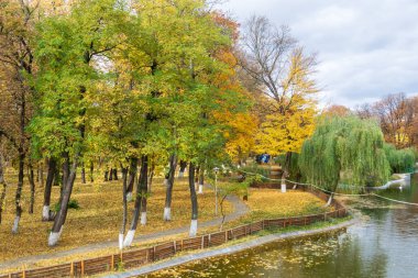 The lake from the Roman park in the autumn surrounded by colored trees, Romania