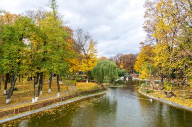 The lake from the Roman park in the autumn surrounded by colored trees, Romania