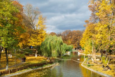The lake from the Roman park in the autumn surrounded by colored trees, Romania
