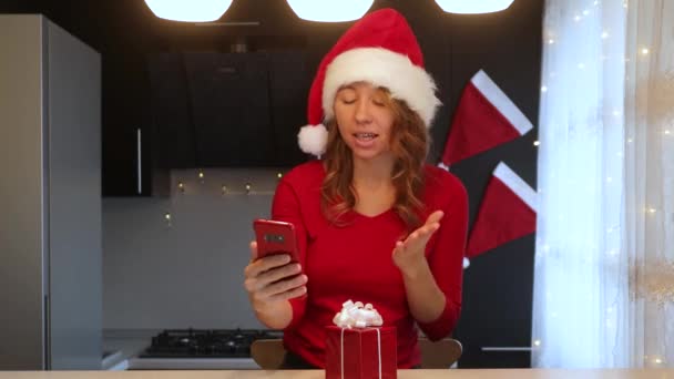 Kırmızı Takım Elbiseli Bir Kız Mutfaktaki Akıllı Telefonun Video Bağlantısıyla — Stok video