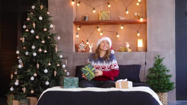 Uma Menina Vestida Papai Noel Pega Uma Caixa Com Presente — Vídeo de Stock