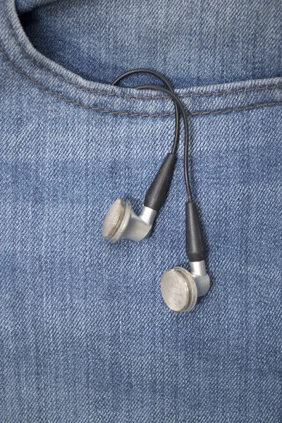 Earphones in pocket Stock Image