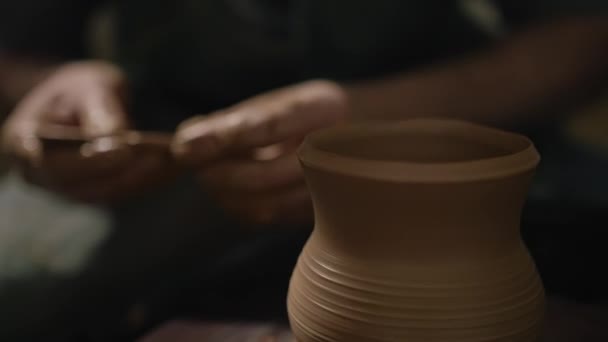 Craftsman hands shaping a jug from a clay on a potters wheel in slow motion — Stock Video