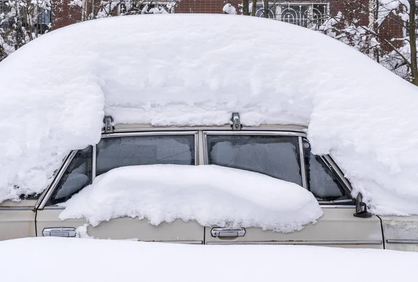 大雪过后被雪完全覆盖的汽车在住宅楼的院子里 — 图库照片