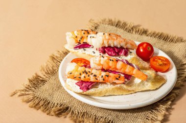 Open sandwiches with boiled shrimps, cream cheese, salad leaves and cherry tomatoes. Seafood, healthy food. Light beige background, copy space