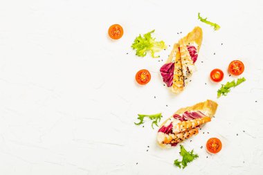 Open sandwiches with boiled shrimps, cream cheese, salad leaves and cherry tomatoes. Seafood, healthy food. White putty background, creative flat lay, top view