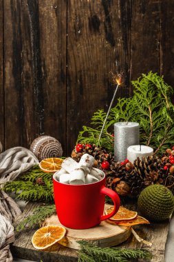Hot cocoa or chocolate with marshmallows and sparklers. Christmas traditional decor, New Year festive arrangement. The concept of coziness, wooden background
