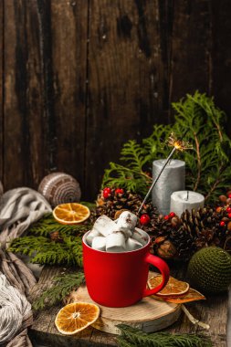 Hot cocoa or chocolate with marshmallows and sparklers. Christmas traditional decor, New Year festive arrangement. The concept of coziness, wooden background