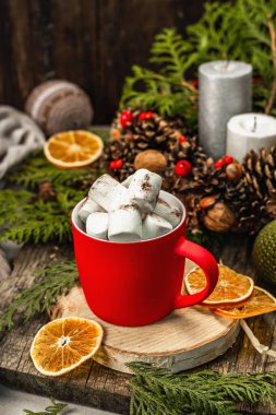 Hot cocoa or chocolate with marshmallows. Christmas traditional decor, New Year festive arrangement. The concept of coziness, wooden background