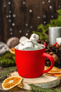 Hot cocoa or chocolate with marshmallows. Christmas traditional decor, New Year festive arrangement. The concept of coziness, wooden background
