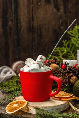 Hot cocoa or chocolate with marshmallows and sparklers. Christmas traditional decor, New Year festive arrangement. The concept of coziness, wooden background