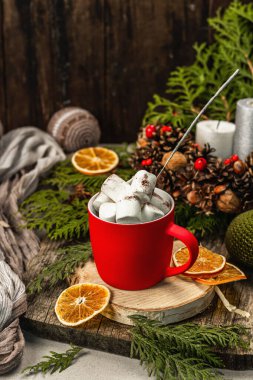 Hot cocoa or chocolate with marshmallows and sparklers. Christmas traditional decor, New Year festive arrangement. The concept of coziness, wooden background