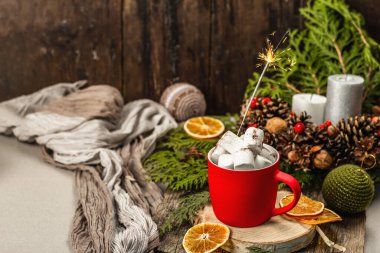 Hot cocoa or chocolate with marshmallows and sparklers. Christmas traditional decor, New Year festive arrangement. The concept of coziness, wooden background, copy space
