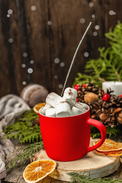 Hot cocoa or chocolate with marshmallows and sparklers. Christmas traditional decor, New Year festive arrangement. The concept of coziness, wooden background