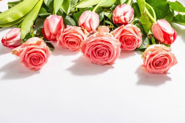 Beyaz arka planda izole edilmiş taze gül buketi ve laleler. Romantik hediye konsepti, pembe çiçekler. Anneler, Sevgililer Günü ya da Kadınlar Günü. Model, şablon, tebrik kartı, düz uzanma
