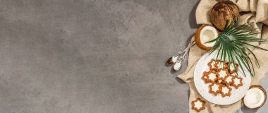 Glütensiz ve laktozsuz hindistan cevizli kurabiye. Ev yapımı sağlıklı hamur işleri, vejetaryen yaşam tarzı. Modaya uygun sert ışık, koyu gölge, gri taş beton zemin, afiş biçimi