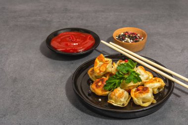 Domates soslu ve biberli kızarmış hamur köftesi. Moda vejetaryen yemekleri, modern sert ışık, karanlık gölge. Taş beton arkaplan, kopyalama alanı