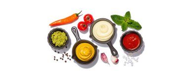 Set of sauces and fresh vegetables isolated on white background. Ketchup, mustard, mayonnaise, wasabi. Spices and herbs, trendy hard light, dark shadow, banner format