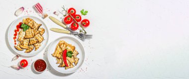 Fried slices Pleurotus eryngii mushrooms with sauce, spices and herbs. Healthy vegan food concept, hard light, dark shadowwhite plaster background, flat lay, banner format