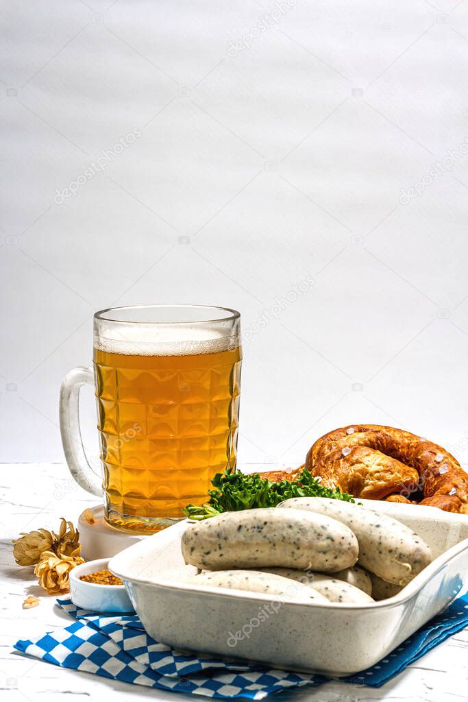 Traditional Oktoberfest set. Pretzels, beer, weisswurst with mustard. German festival food concept. Trendy hard light, dark shadow, white putty background, copy space