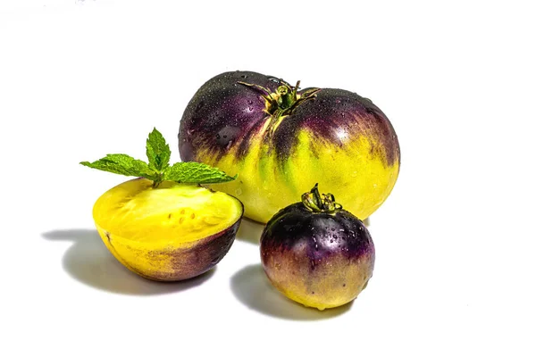 Yellow-violet Tomatoes variety Primary colors isolated on white background. Harvest of ripe vegetables, trendy hard light, dark shadow