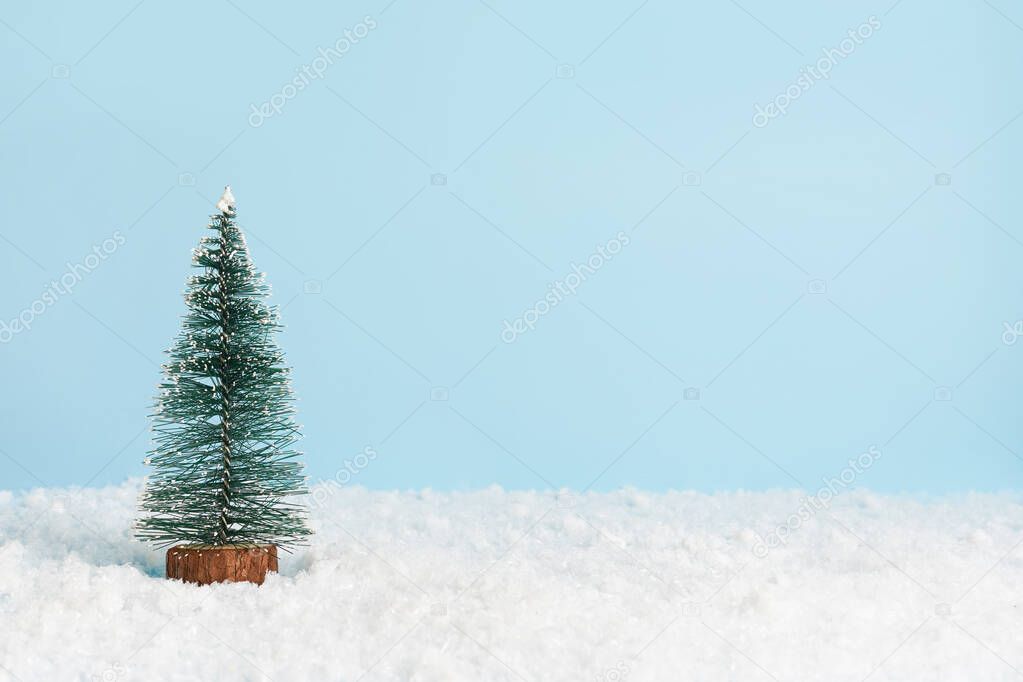 Decorated christmas tree on blue background, greeting card with copy space