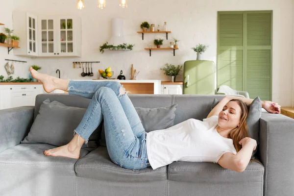 Young attractive woman relaxing on sofa at home