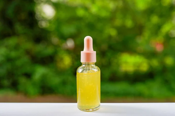 Glass Transparent Yellow Bottle Cosmetics Acids Oils Nature Green Background — Stock Photo, Image