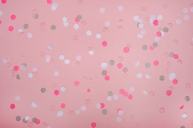 Pembe arka planda renkli parti konfetileri. Üst manzara, düz uzanma